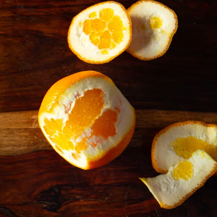 An orange that's partially peeled.