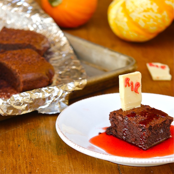 A plate with a chocolate brownie with a strawberry syrup for Halloween.  