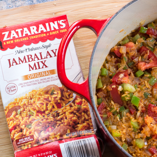 Package of Zatarains Jambalaya Mix and a pot full of vegetarian jambalaya. 