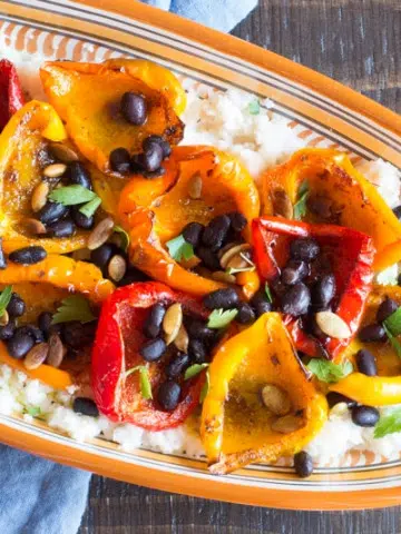 Cajun-spiced peppers and beans over cheesy cauliflower grits.