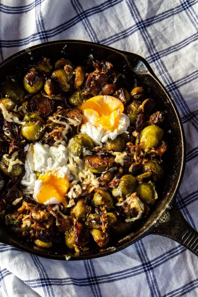 Low-carb, keto-friendly balsamic roasted Brussels sprouts and onions with fried eggs for the win. Perfect vegetarian, healthy dinner that's also a great comfort meal on chilly nights. #BalsamicRoastedBrusselsSprouts #RoastedBrusselsSprouts #BrusselsSprouts #LowCarb #BestLowCarbRecipes #HealthyRecipe #VegetarianDinner