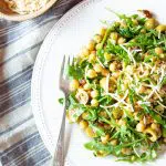 Super-easy super-quick vegan chickpea salad that's ready to eat in 15 minutes. It has green olives, sun-dried tomatoes, arugula and my favorite vegan Parmesan-style cheese on top.