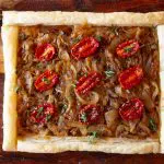 Step-by-step instructions for making a French onion tart with photos. Mushrooms and tomatoes are added for extra umami. This makes a perfect fall supper or party appetizer.
