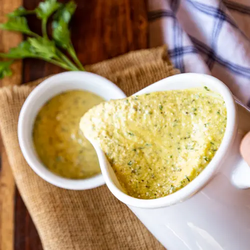 Pouring Sauce Gribiche into a ramekin.