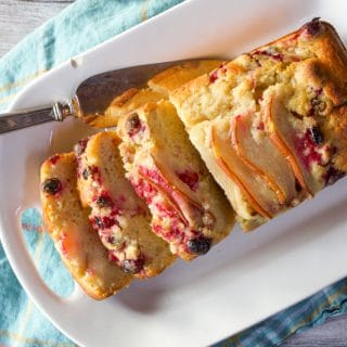 Sliced yogurt cake with pears, cranberries and chocolate chips.