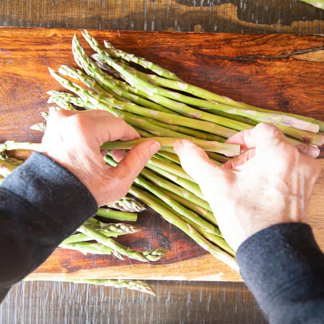Snapping off the ends of asparagus spears.