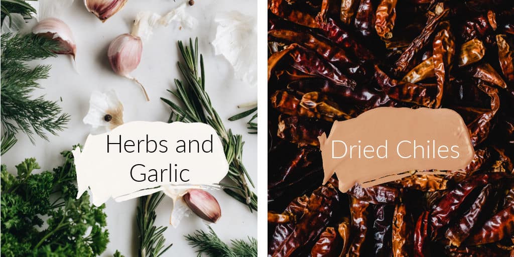 Herbs, garlic and dried chiles spread out on a countertop.