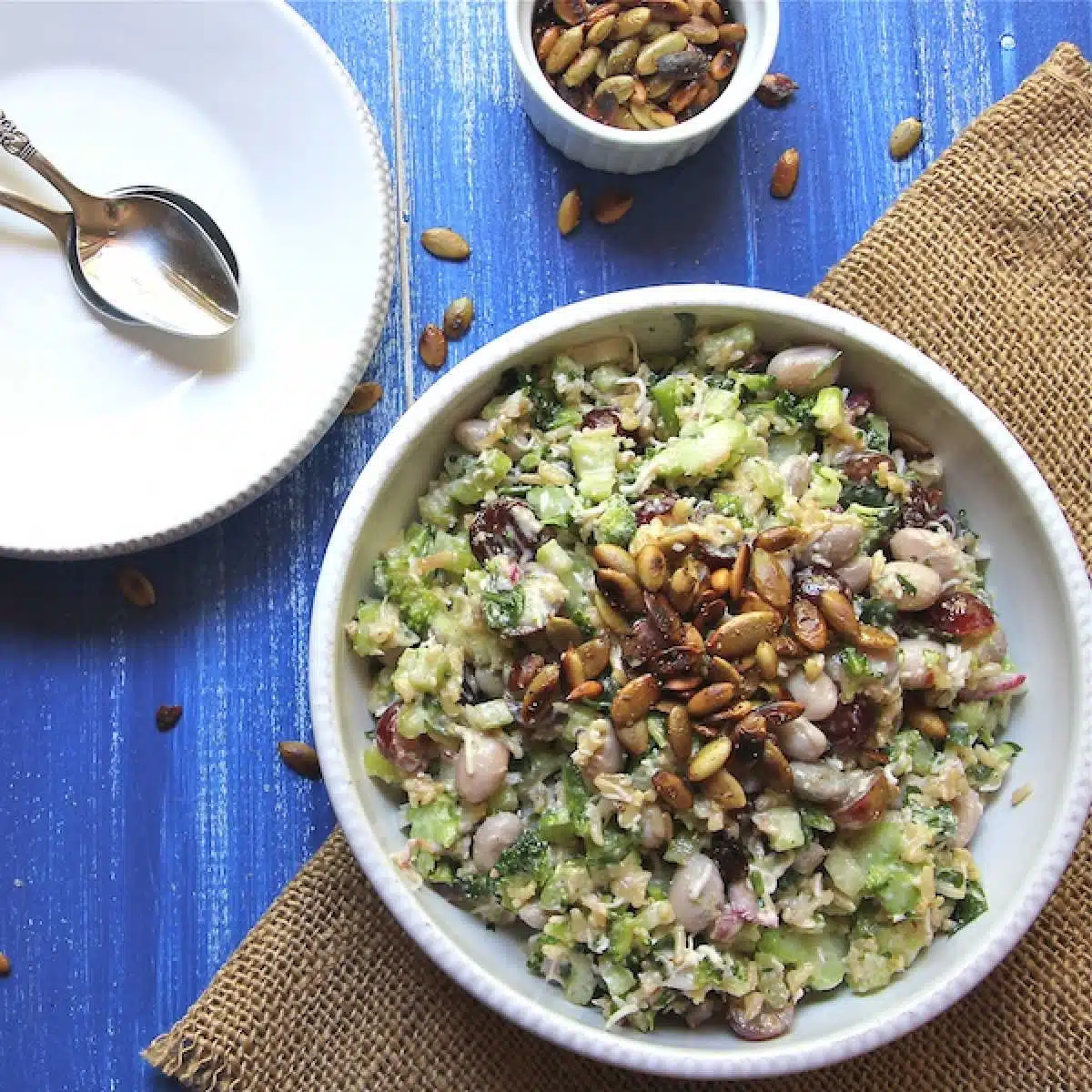 Broccoli salad with white beans and rice, and dried cherries, topped with roasted pumpkin seeds.