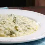 A plate of creamy risotto with asparagus, cooked in the slow cooker.