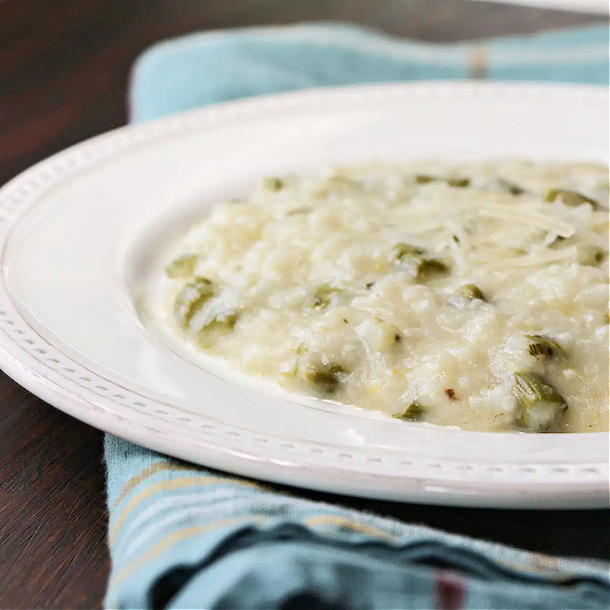 A plate of super creamy asparagus risotto cooked in the slow cooker.