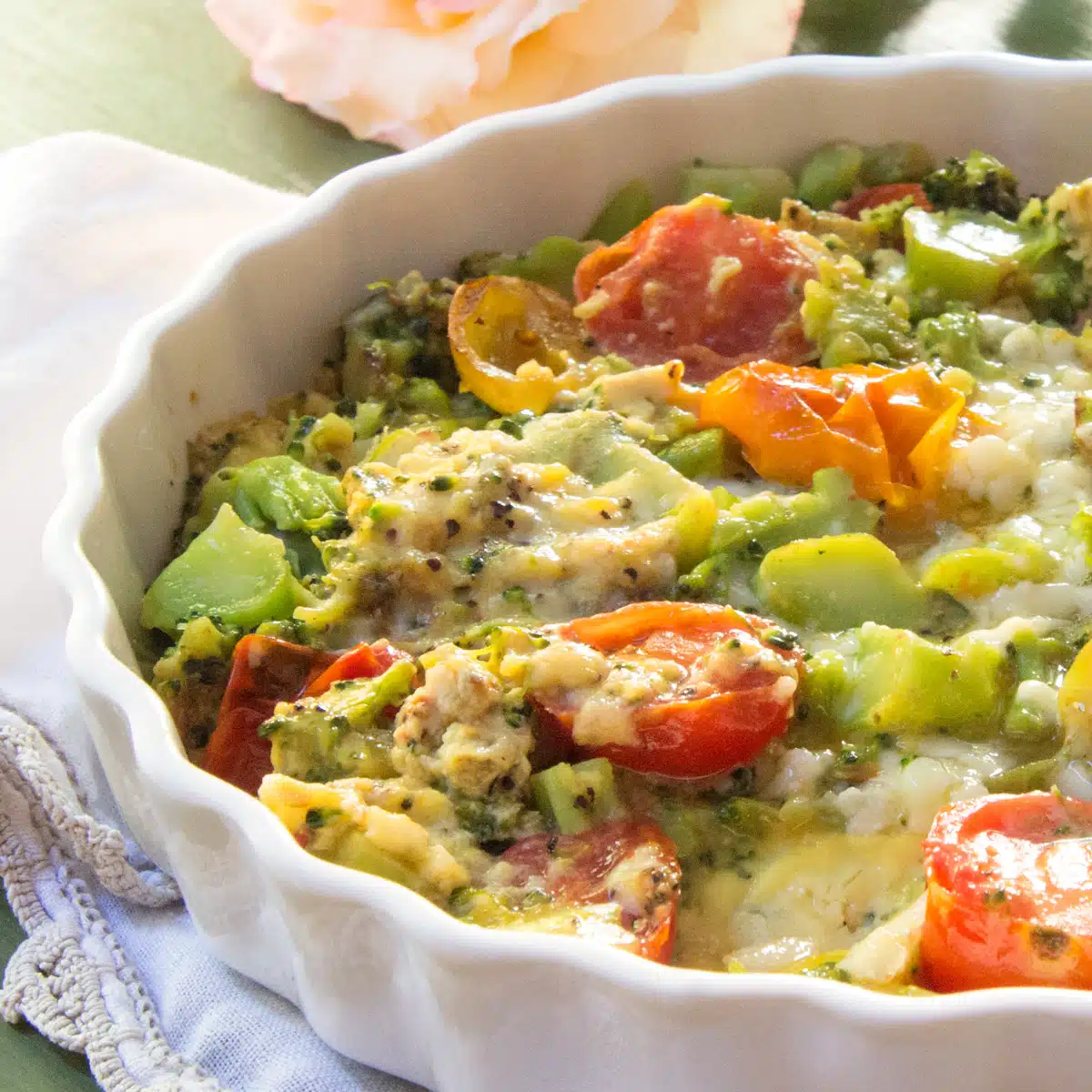 A frittata of eggs cooked with broccoli, cheddar cheese and tomatoes.
