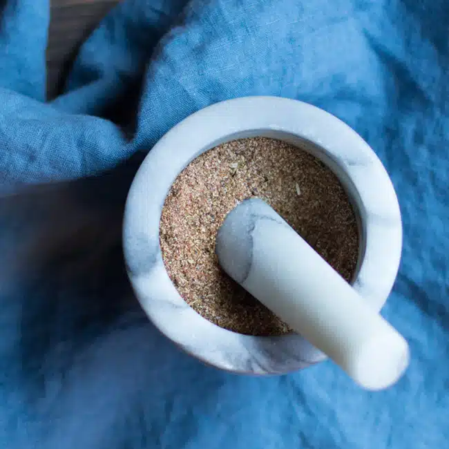 A mortar and pestle with a Cajun spice mix.