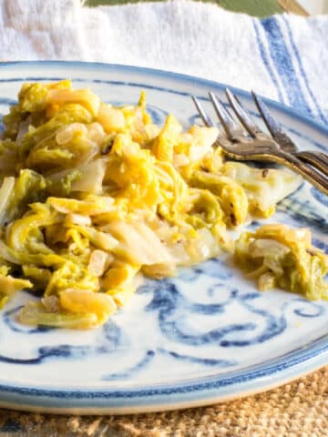 Braised cabbage on a plate with two small forks.