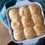 Freshly baked potato rolls with chives still in a baking dish.