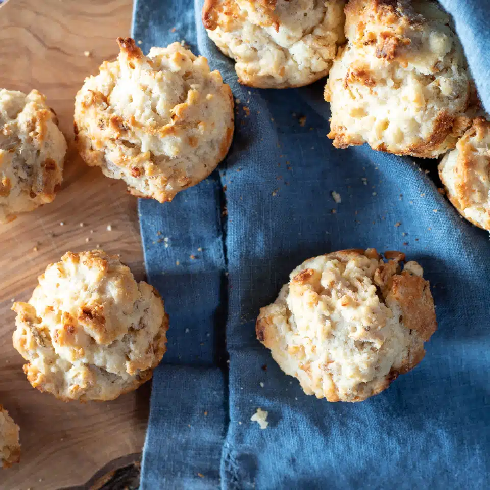 Bisquick muffins scattered across the wooden board and napkin.