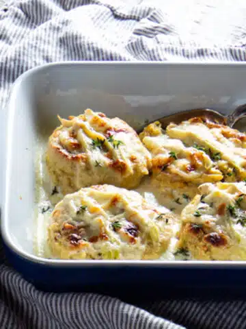 A baking dish of double baked cheese soufflés with artichokes.