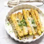 Breaded zucchini sticks topped with parsley and parmesan cheese.