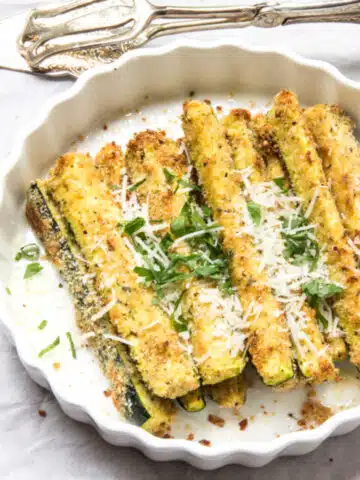 Breaded zucchini sticks topped with parsley and parmesan cheese.