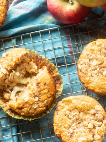Top view of apple oatmeal muffins with cheddar cheese on a cooling rack.