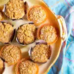 A serving dish filled with pumpkin muffins made with applesauce.