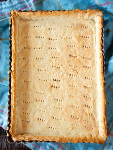 A baked pie crust in a tart pan.