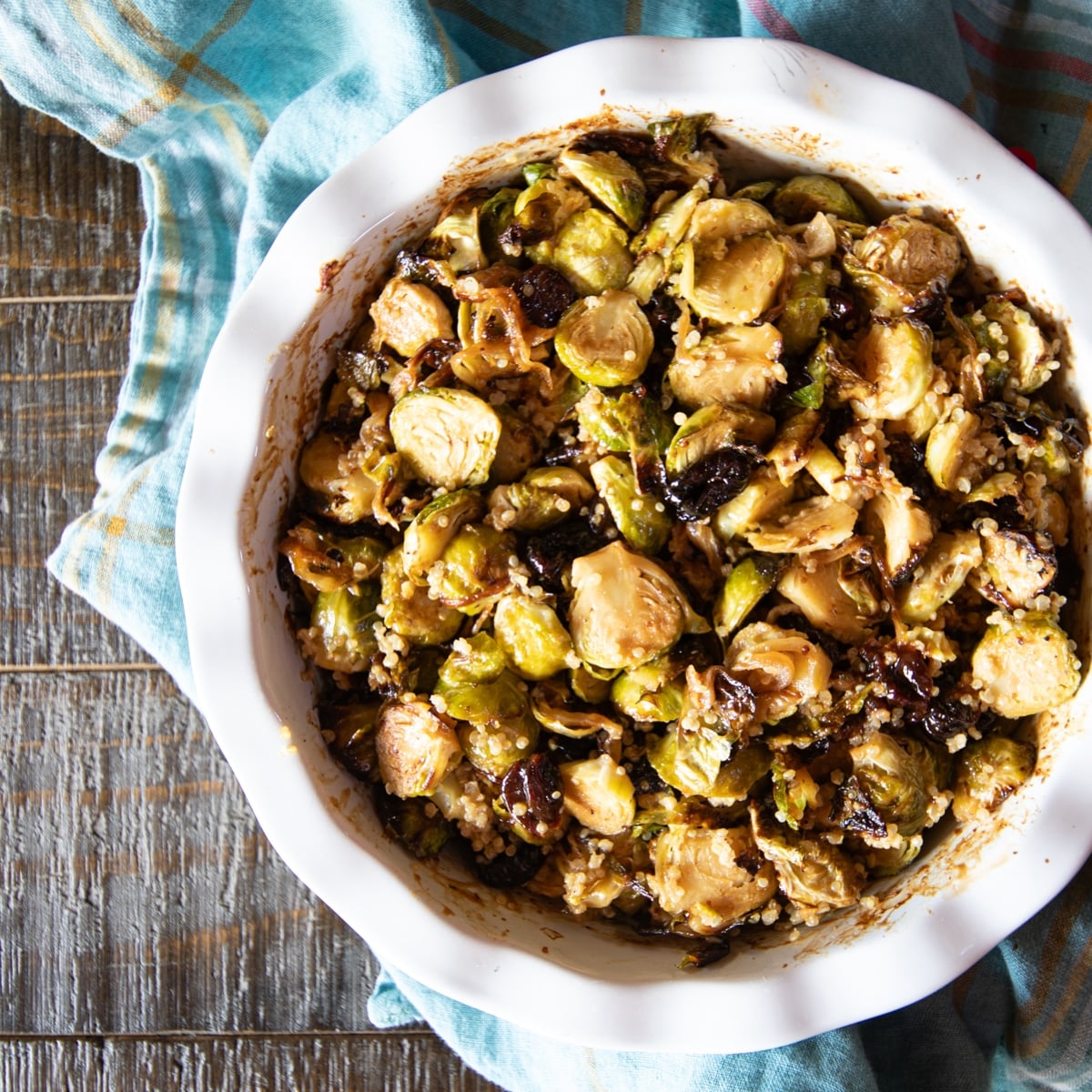 A baking dish filled with air fryer Brussels sprouts, quinoa, caramelized onions, and dried cherries.